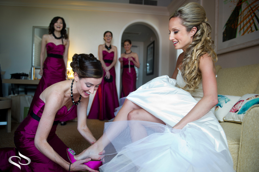 Bride getting shoes on at her Don Cesar Wedding