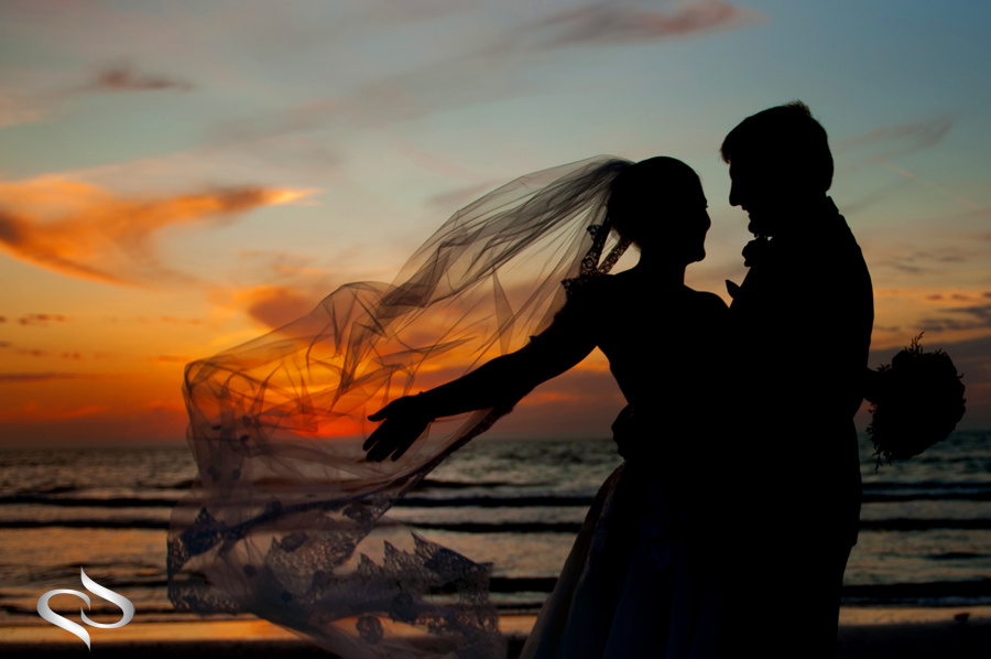 Bride with veil in the wind on St. Petersburg Beach