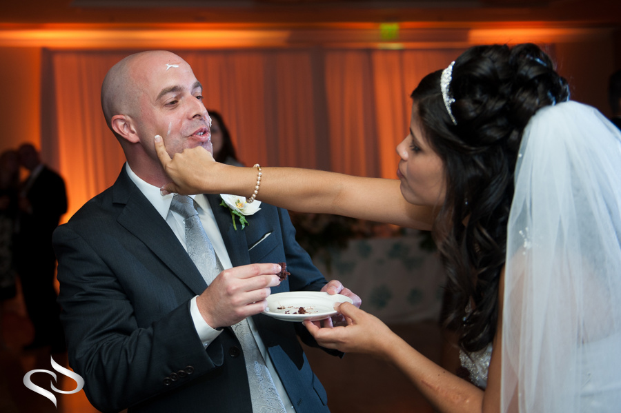 Bride puts cake all over groom