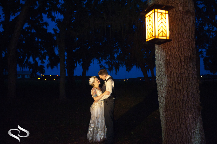 Bride under lantern in Claire Pettibone dress 